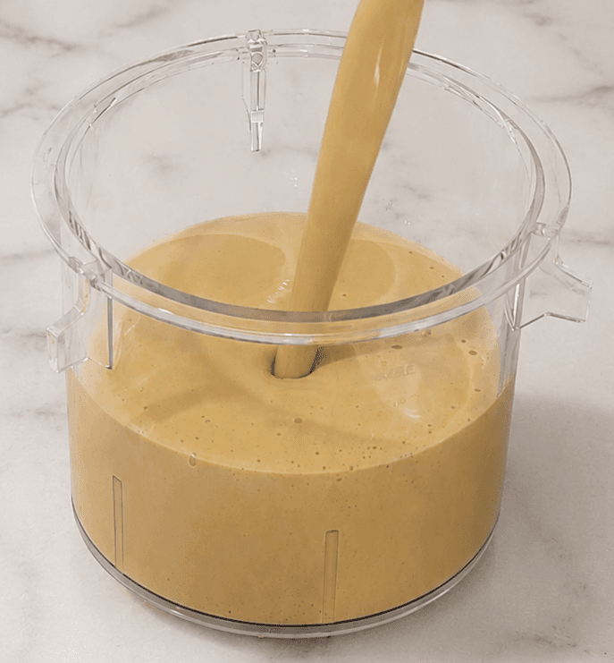 Pouring a smooth dessert base into the CONIVO container
